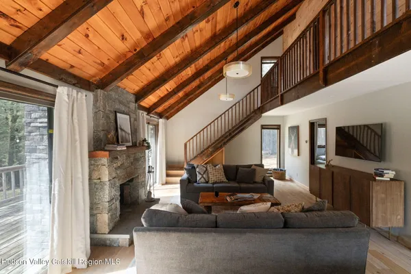 a living room with furniture a flat screen tv and a fireplace