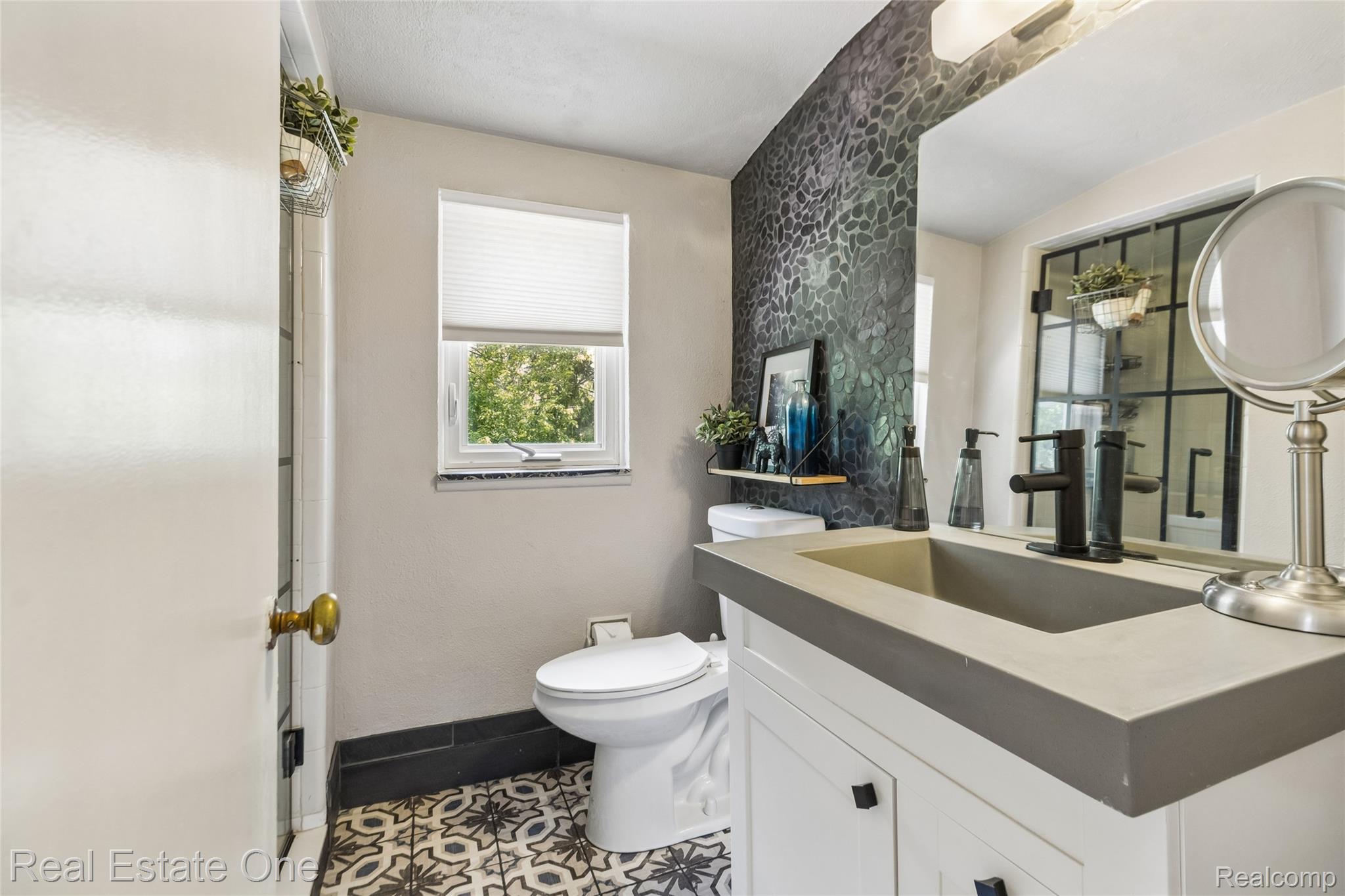 2189 Devonshire Road Bloomfield Hills, MI 48302 - Photo 30 of 50 Bathroom featuring a concrete-finish vanity with an integrated sink and a matte black faucet