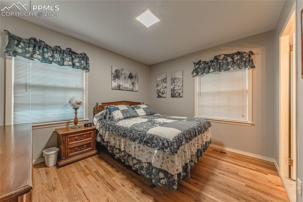 1407 Alexander Road Colorado Springs, CO 80909 - Photo 13 of 27 a bedroom with a bed and a window
