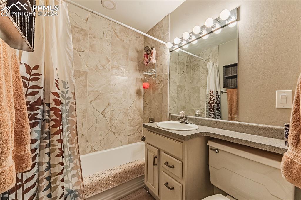 1407 Alexander Road Colorado Springs, CO 80909 - Photo 16 of 27 a bathroom with a sink and a bathtub