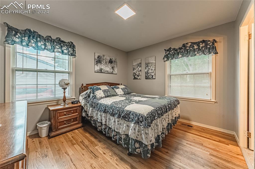 1407 Alexander Road Colorado Springs, CO 80909 - Photo 17 of 27 a bedroom with a bed and a large window
