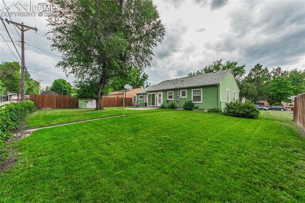1407 Alexander Road Colorado Springs, CO 80909 - Photo 23 of 27 a front view of house with yard and green space
