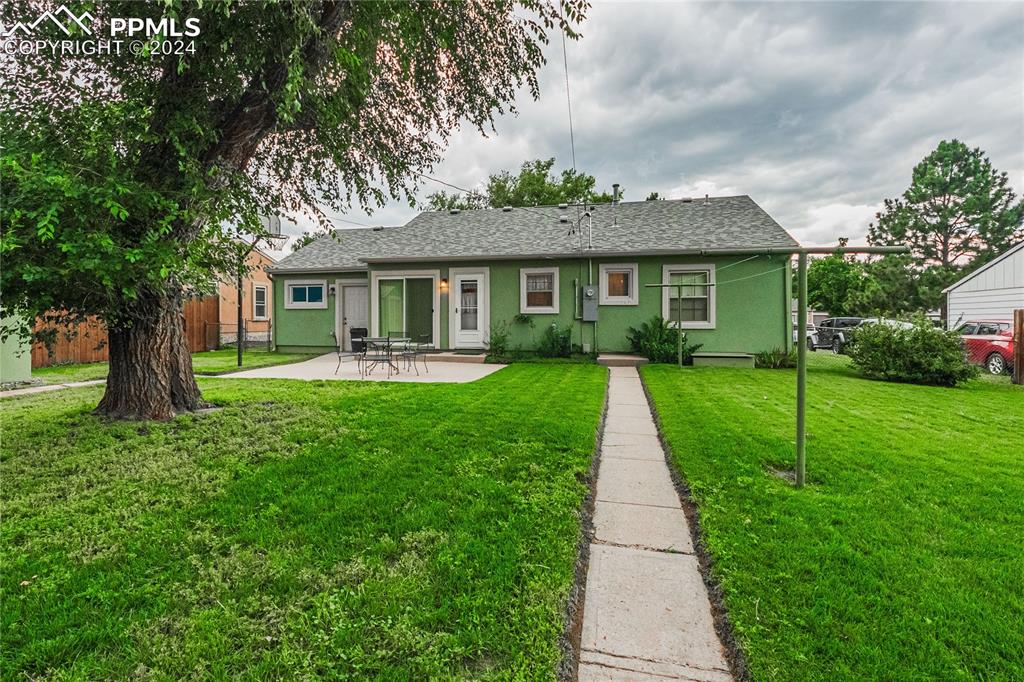1407 Alexander Road Colorado Springs, CO 80909 - Photo 24 of 27 a view of a house with a yard