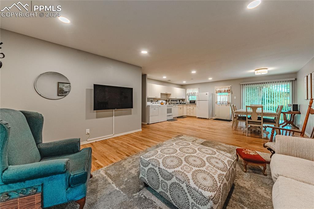 1407 Alexander Road Colorado Springs, CO 80909 - Photo 5 of 27 a living room with furniture and a flat screen tv