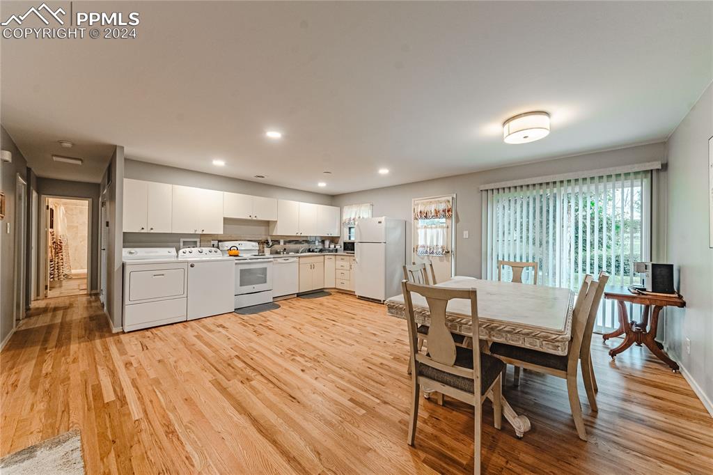 1407 Alexander Road Colorado Springs, CO 80909 - Photo 6 of 27 a view of a dining room with furniture and wooden floor