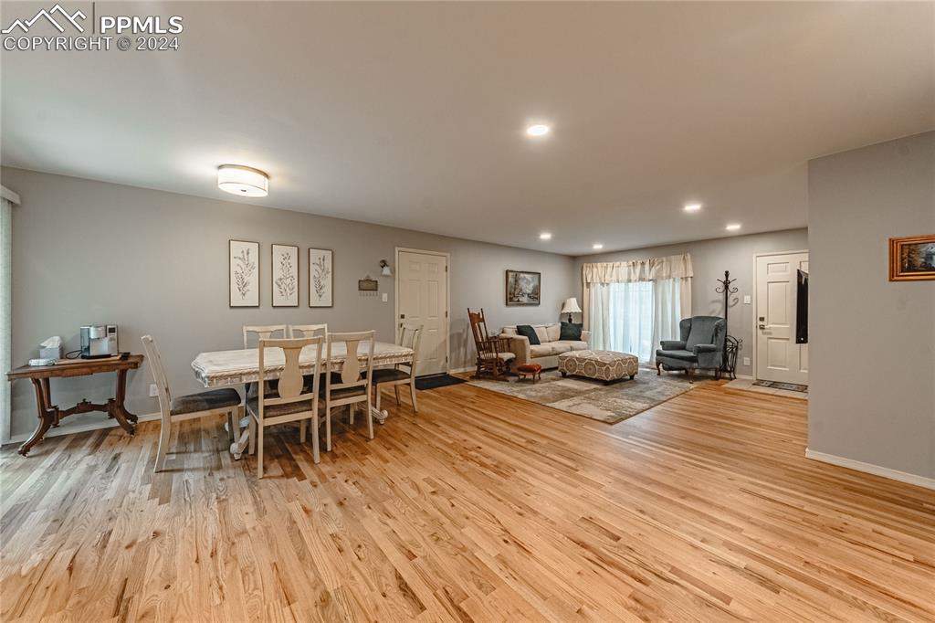 1407 Alexander Road Colorado Springs, CO 80909 - Photo 9 of 27 a living room with furniture and a wooden floor