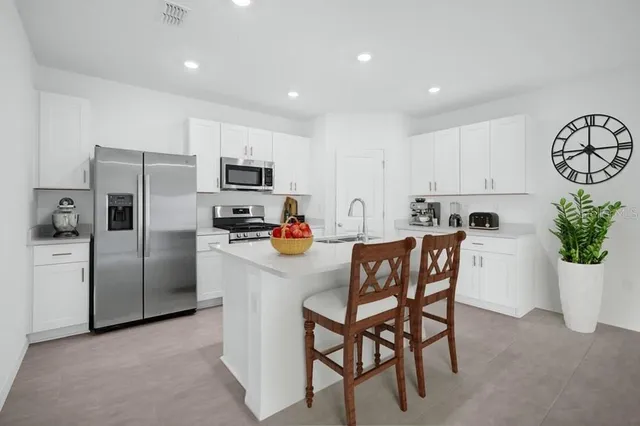 a view of a kitchen with stairs and ventilation