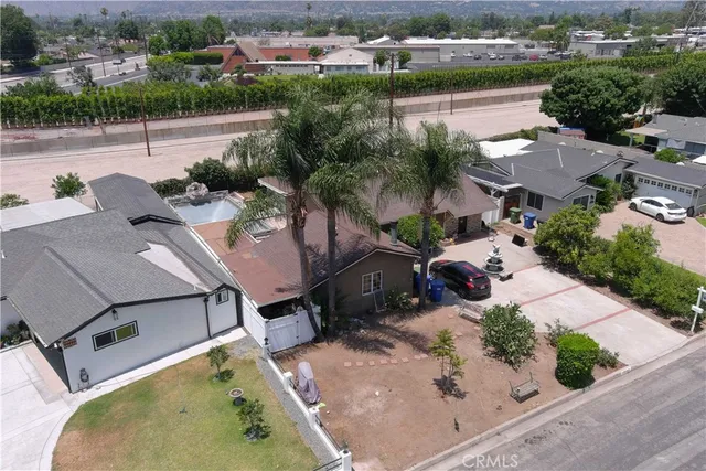 an aerial view of a house with a garden and lake view