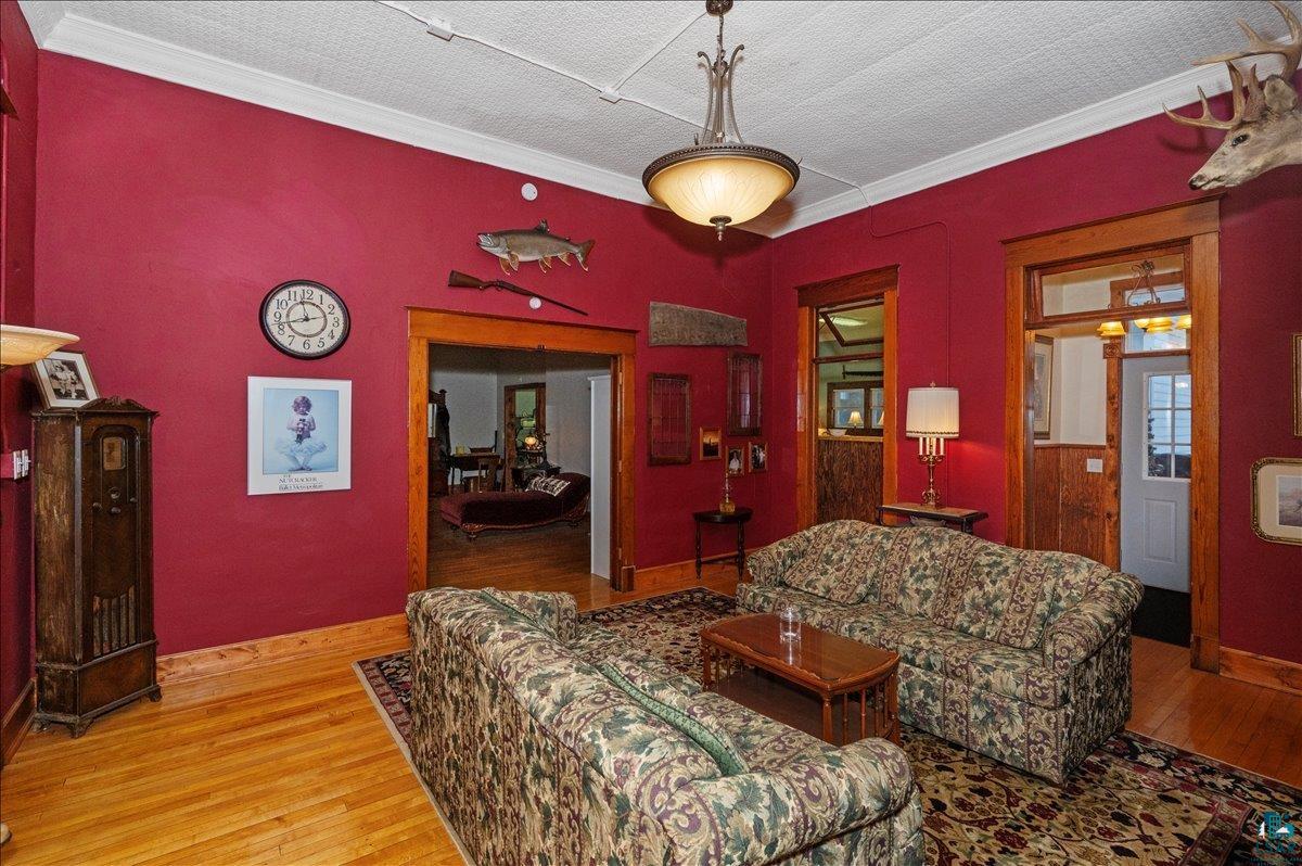 7596 Werner Road Virginia, MN 55792 - Photo 12 of 27 Room featuring hardwood flooring, pressed tin ceiling, and wood-trimmed doorways