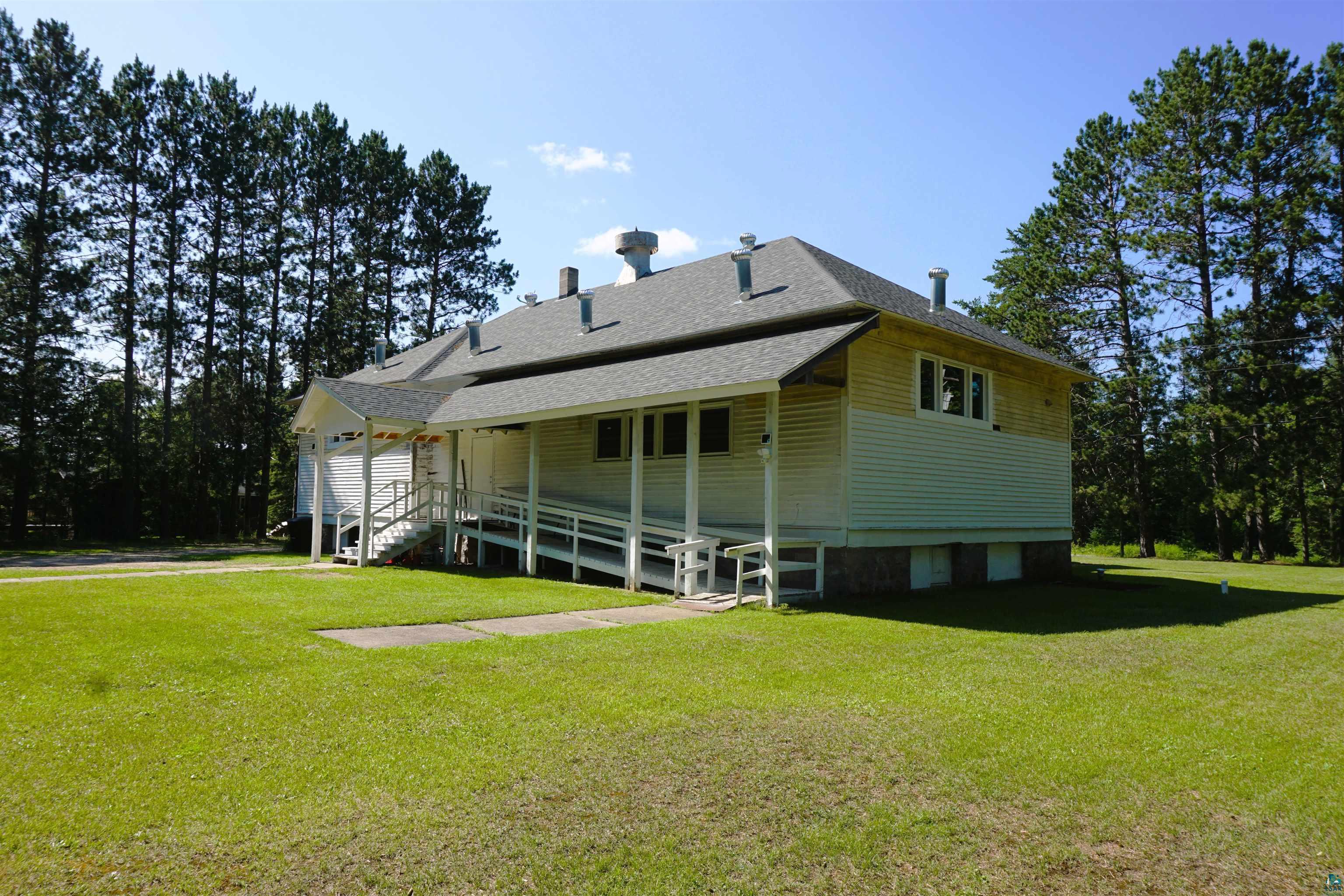7596 Werner Road Virginia, MN 55792 - Photo 27 of 27 Building exterior featuring white siding, a covered porch, and a gray shingle roof
