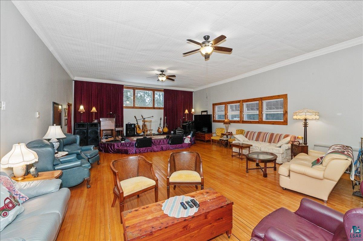 7596 Werner Road Virginia, MN 55792 - Photo 3 of 27 Expansive room featuring wood-finish flooring, a patterned ceiling, and multiple windows with wood trim
