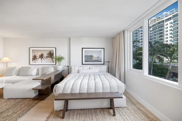 a bed sitting in a bedroom next to a window