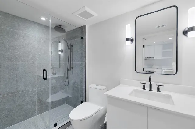 a bathroom with a sink toilet and shower