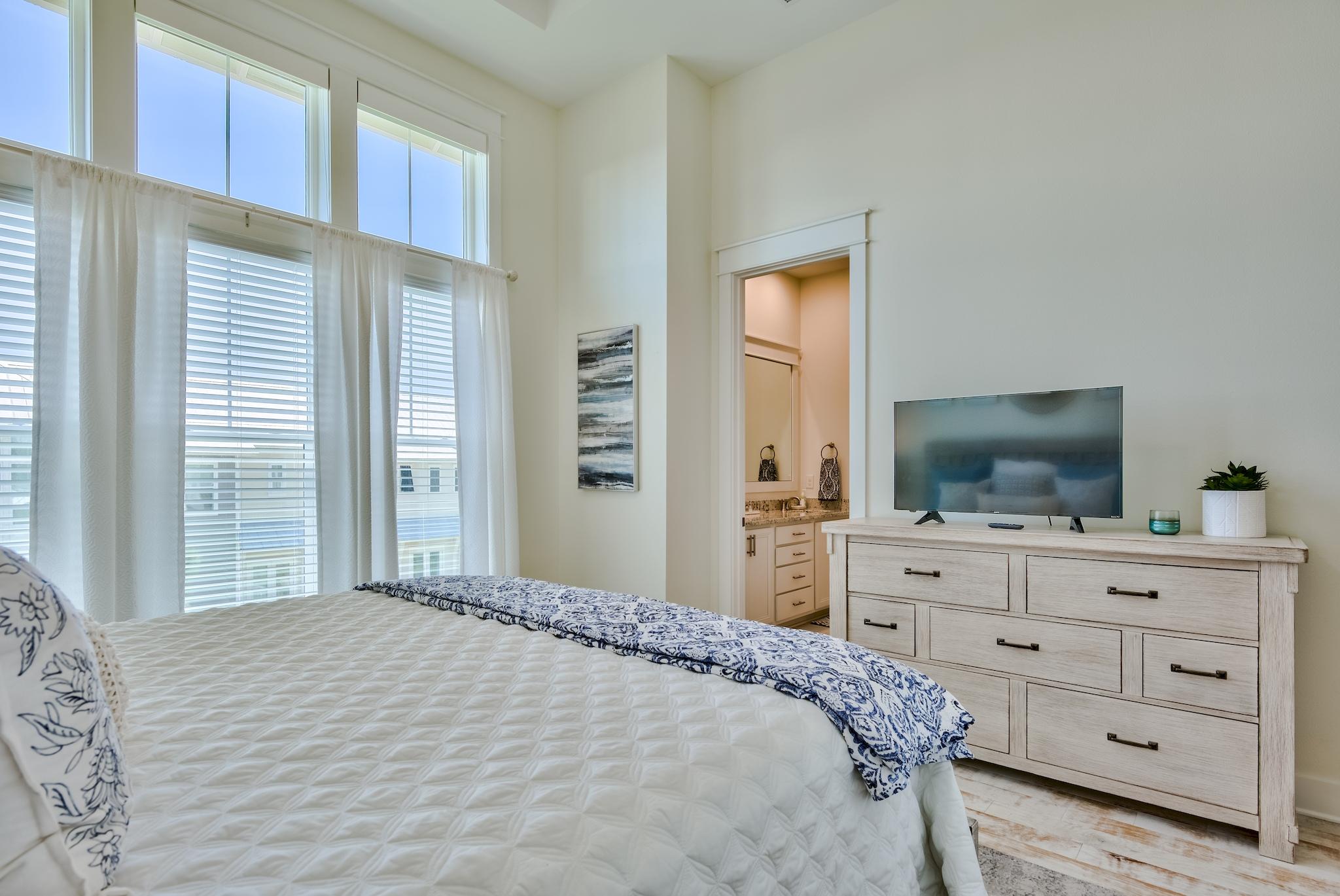308 Milestone Dr Inlet Beach, Unit B Inlet Beach, FL 32461 - Photo 12 of 49 a bedroom with a bed and a flat screen tv