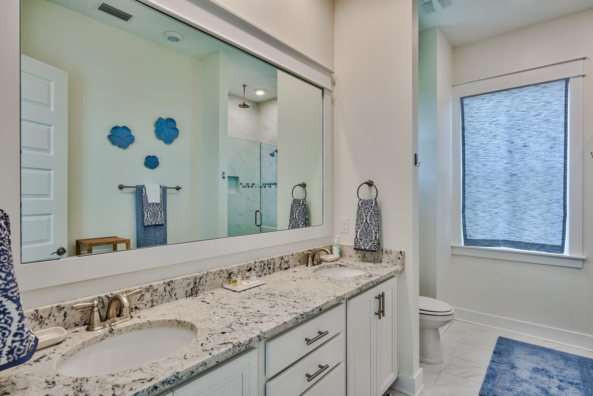308 Milestone Dr Inlet Beach, Unit B Inlet Beach, FL 32461 - Photo 14 of 49 a bathroom with a granite countertop sink and a mirror