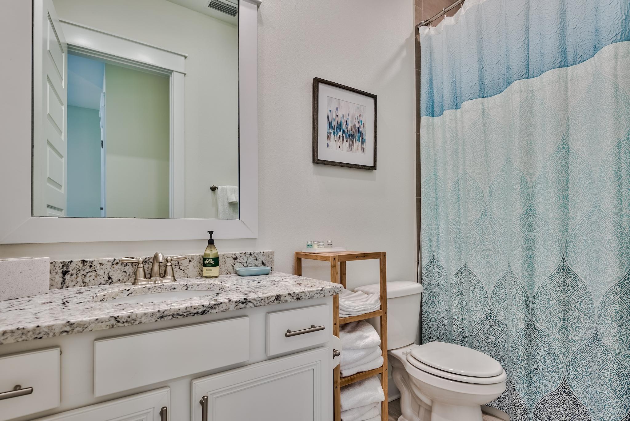 308 Milestone Dr Inlet Beach, Unit B Inlet Beach, FL 32461 - Photo 16 of 49 a bathroom with a granite countertop sink toilet and a mirror