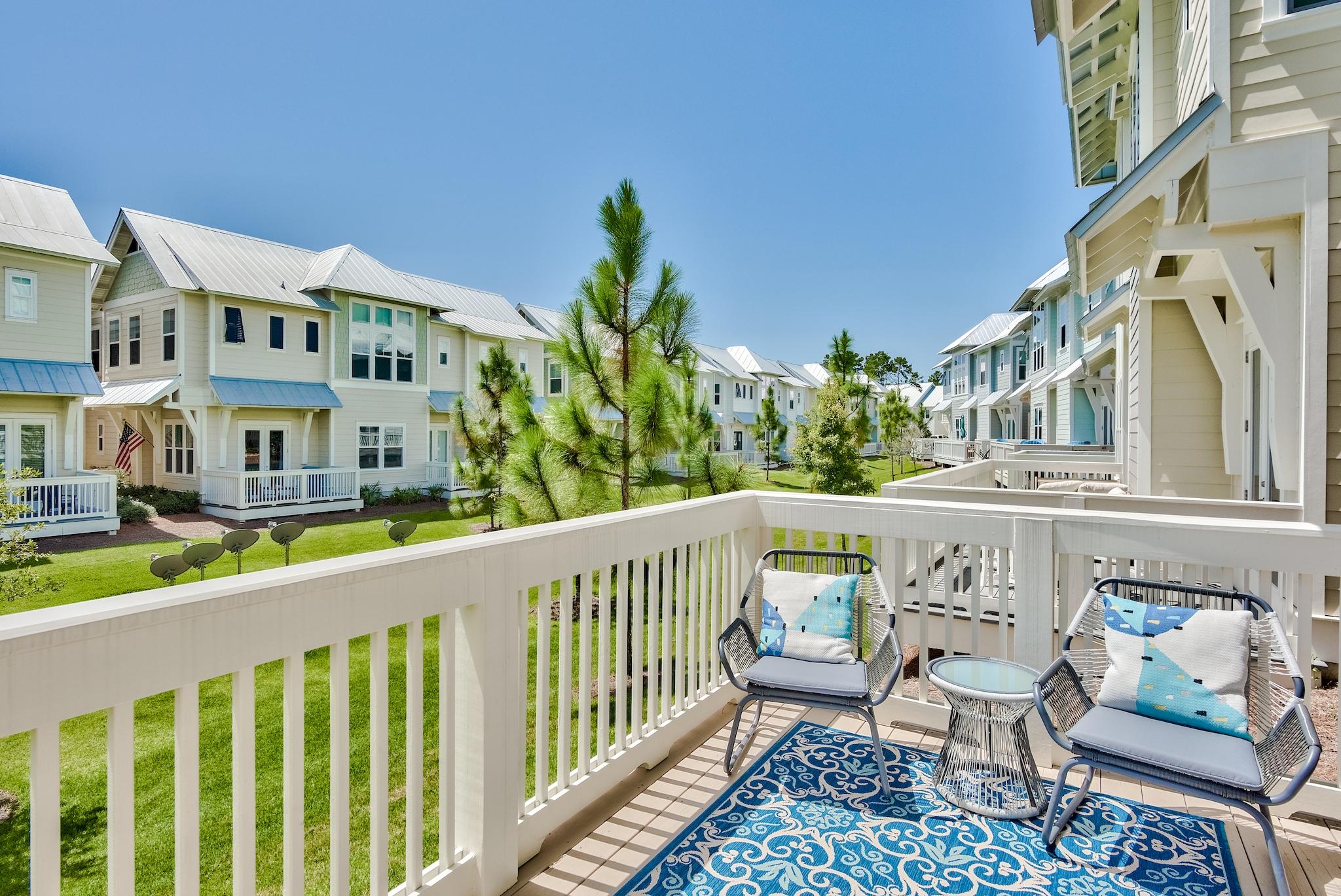 308 Milestone Dr Inlet Beach, Unit B Inlet Beach, FL 32461 - Photo 22 of 49 a view of a chairs and table in the balcony