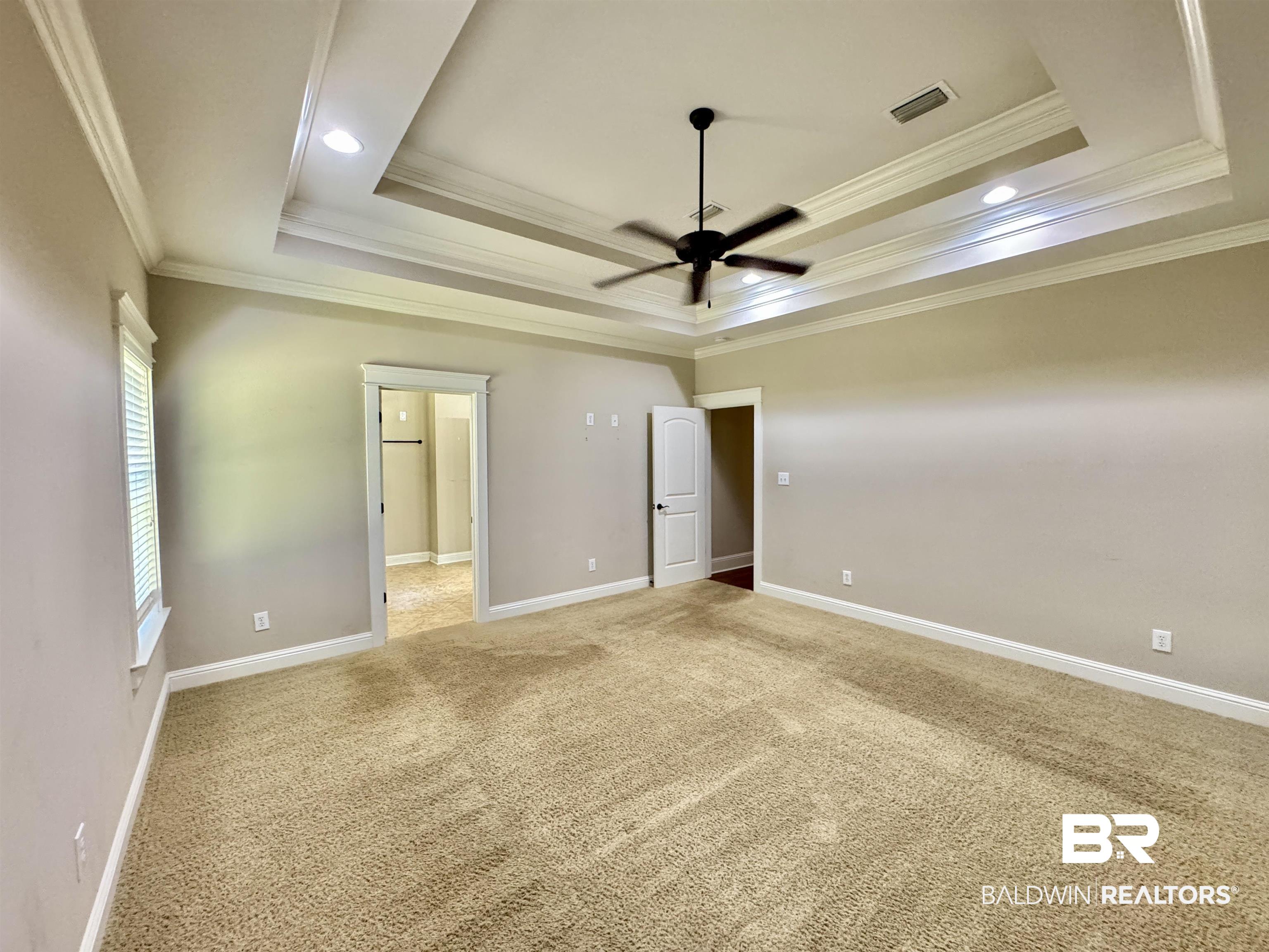 10846 County Road 138 Bay Minette, AL 36507 - Photo 4 of 53 Unfurnished bedroom with carpet, ornamental molding, a tray ceiling, and ceiling fan