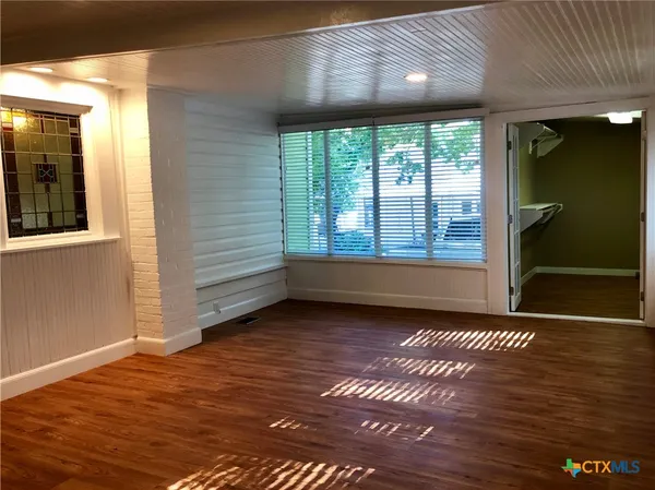 a view of an empty room with glass door