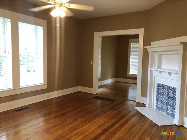 a view of livingroom with hardwood floor and a ceiling fan