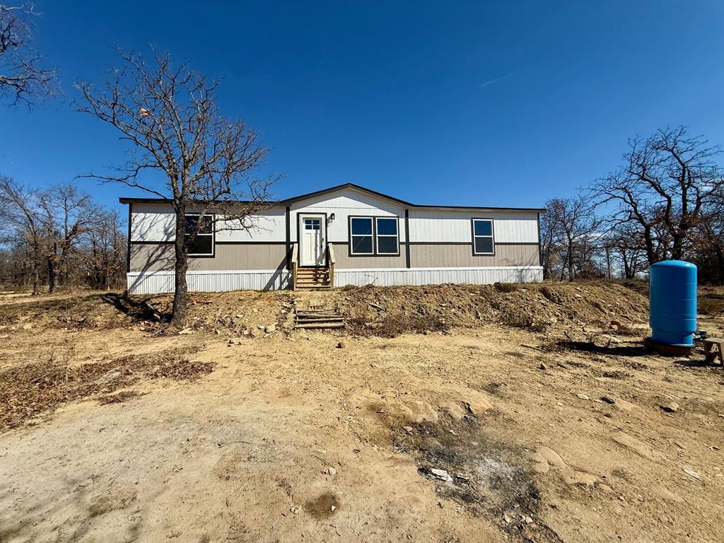 136 County Road 1736 Chico, TX 76431 - Photo 1 of 27 a front view of a house with a yard