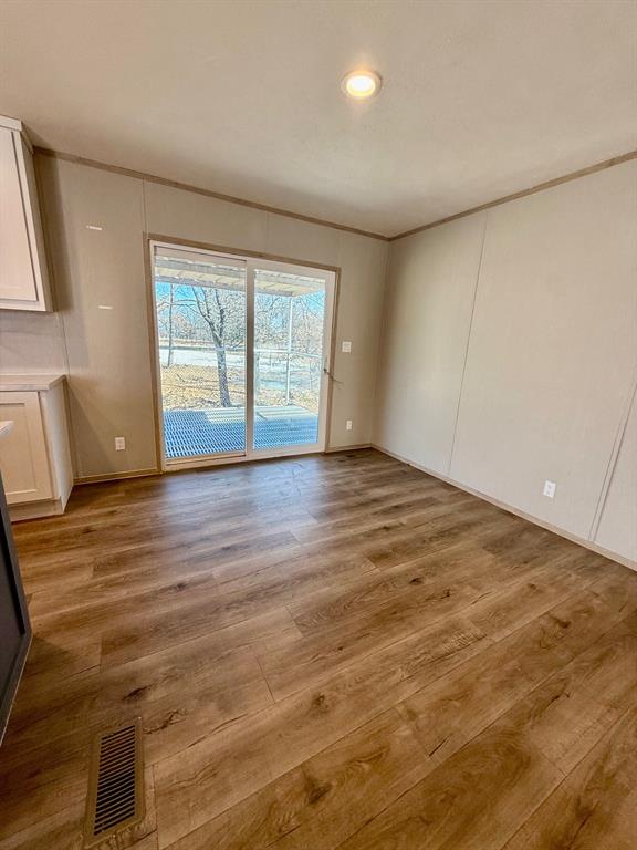 136 County Road 1736 Chico, TX 76431 - Photo 11 of 27 an empty room with wooden floor and window