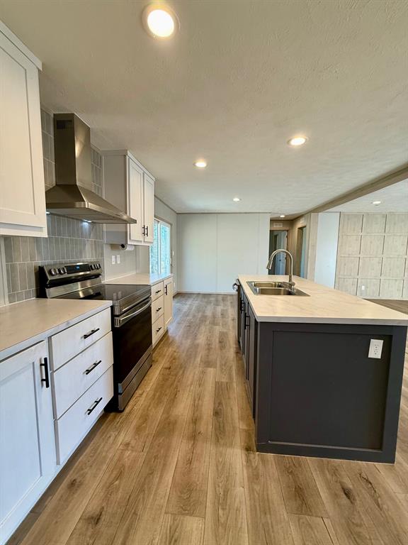 136 County Road 1736 Chico, TX 76431 - Photo 14 of 27 a kitchen with stainless steel appliances granite countertop a sink a stove top oven and wooden floors
