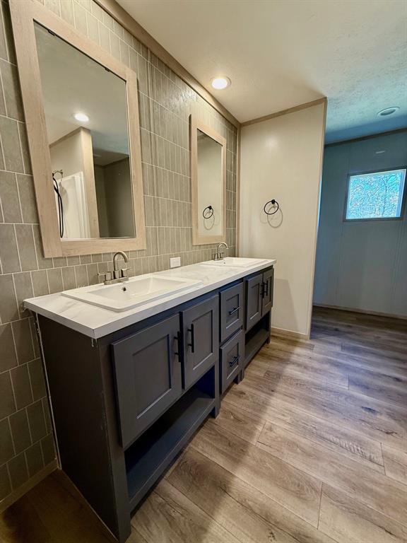 136 County Road 1736 Chico, TX 76431 - Photo 17 of 27 a bathroom with a double vanity sink and a mirror