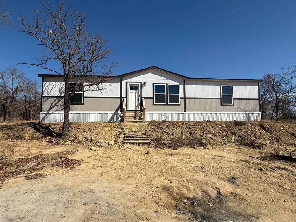 136 County Road 1736 Chico, TX 76431 - Photo 2 of 27 a front view of a house with a yard