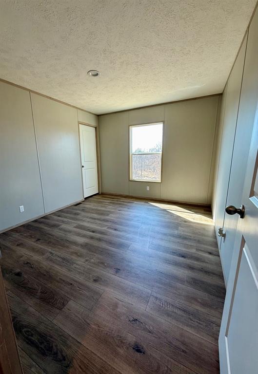 136 County Road 1736 Chico, TX 76431 - Photo 25 of 27 a view of an empty room with wooden floor
