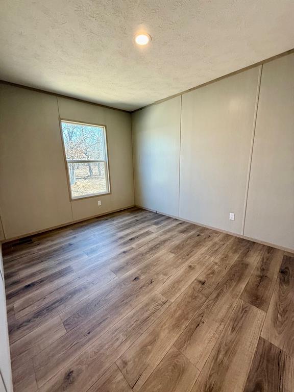 136 County Road 1736 Chico, TX 76431 - Photo 26 of 27 an empty room with wooden floor and window