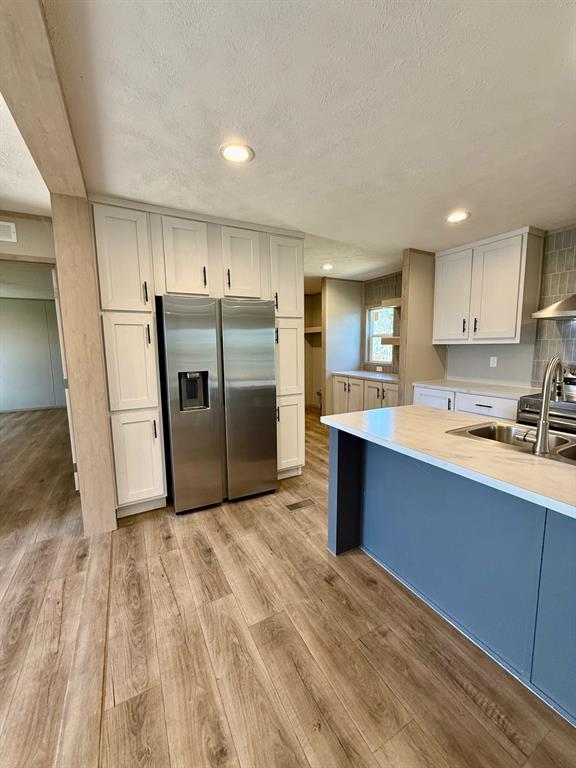 136 County Road 1736 Chico, TX 76431 - Photo 7 of 27 a large kitchen with stainless steel appliances granite countertop a refrigerator and a sink