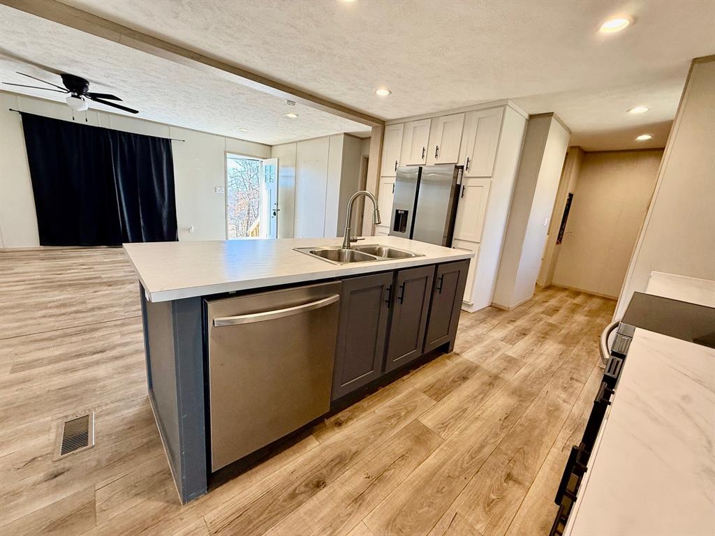 136 County Road 1736 Chico, TX 76431 - Photo 8 of 27 a kitchen with stainless steel appliances a sink stove and refrigerator