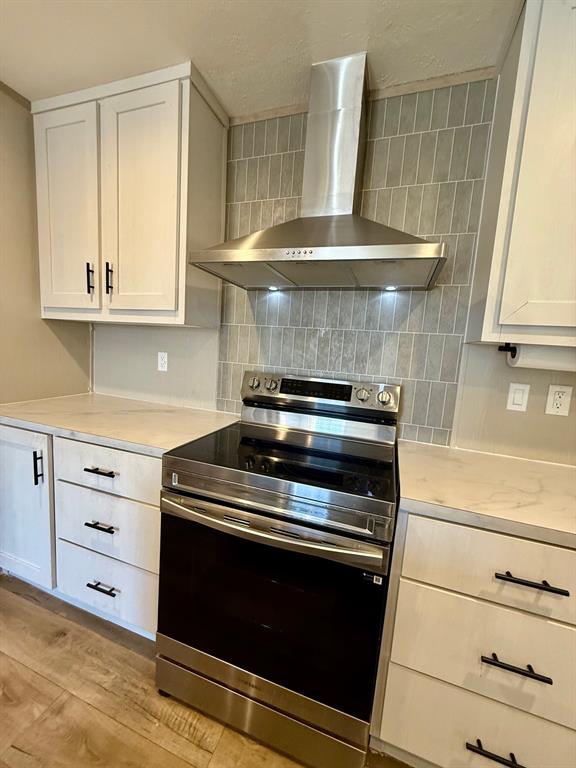 136 County Road 1736 Chico, TX 76431 - Photo 9 of 27 a kitchen with granite countertop a stove and a microwave