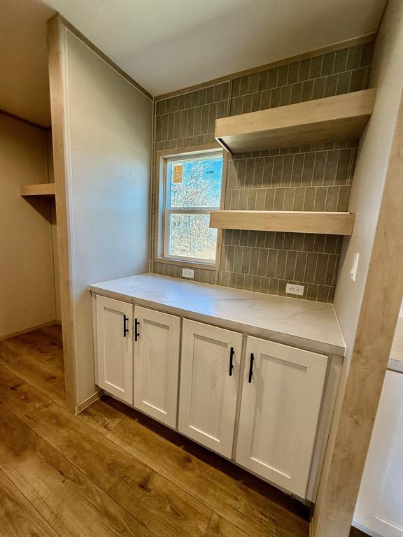 136 County Road 1736 Chico, TX 76431 - Photo 10 of 27 a kitchen with granite countertop a sink and a stove