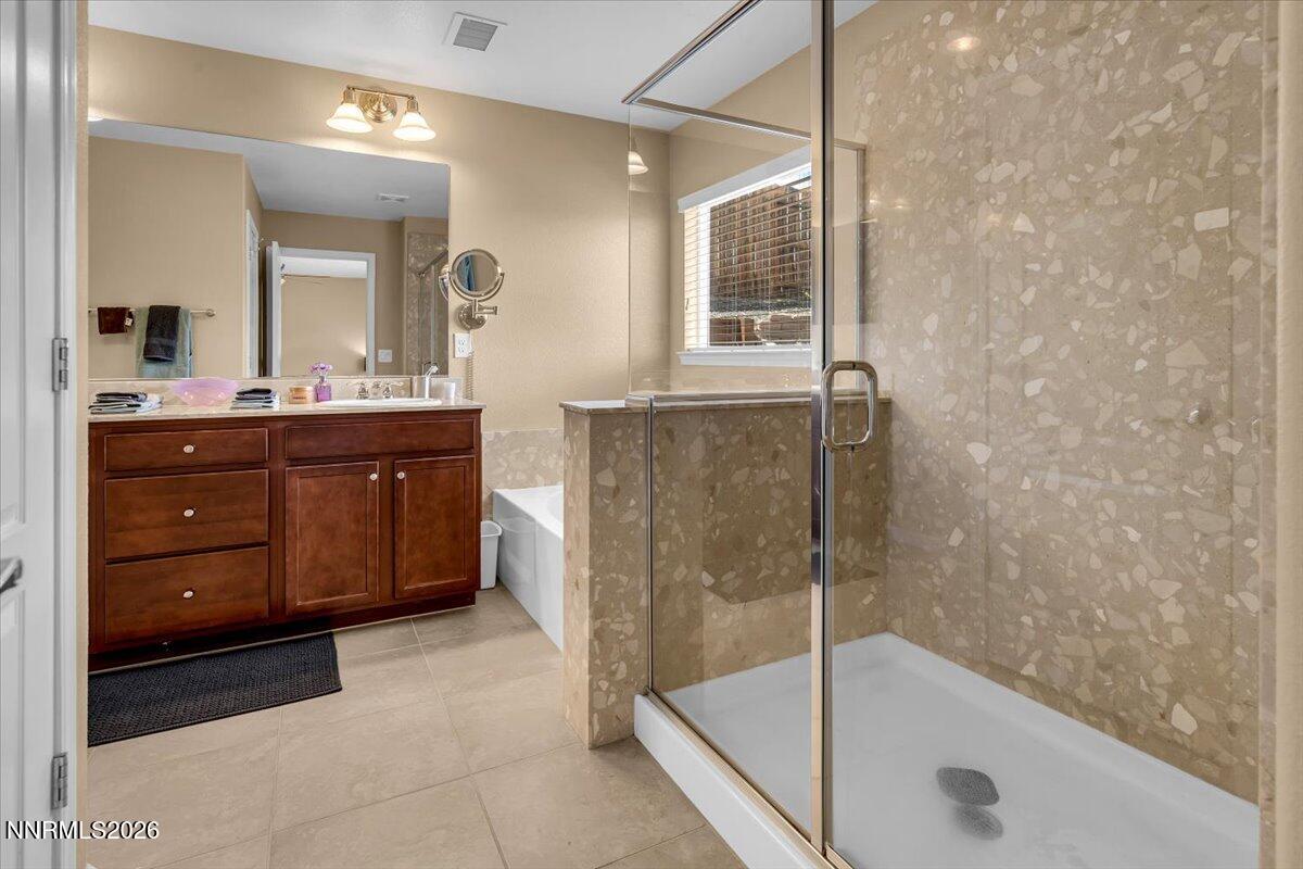 104 Bethpage Road Dayton, NV 89403 - Photo 26 of 65 a bathroom with a tub mirror and sink