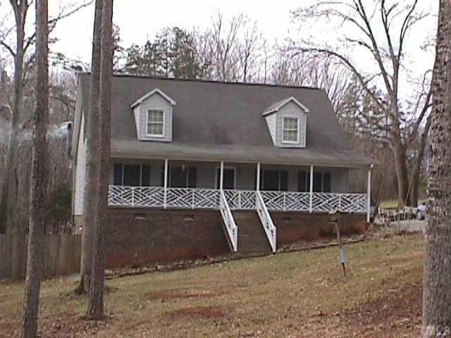 127 Shannon Road Timberlake, NC 27583 - Photo 1 of 1 a front view of a house with a yard and garage