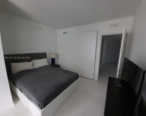 a bedroom with a bed and cabinets