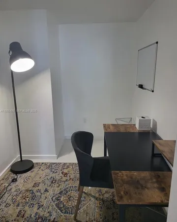 a view of a workspace room with furniture and wooden floor