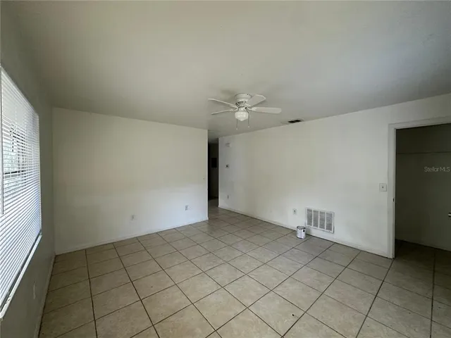 an empty room with a empty space and windows