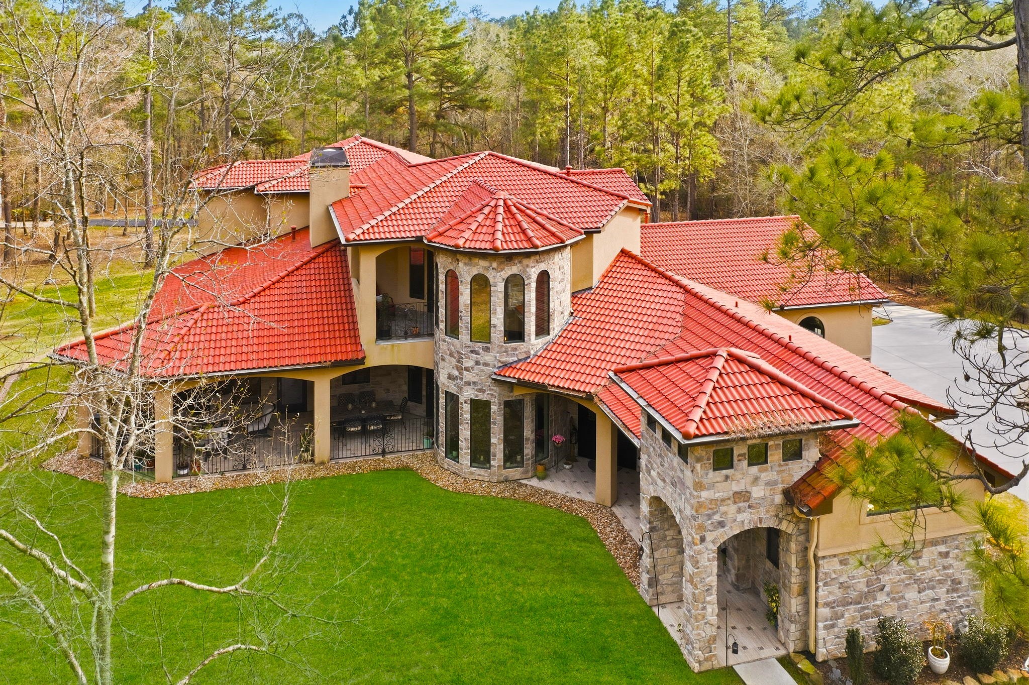 280 Sundog Road Huntsville, TX 77340 - Photo 4 of 50 Aerial perspective showcasing the home’s impressive design, tile roof, and architectural details.
