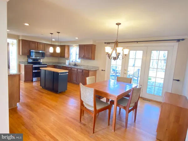 a kitchen with granite countertop wooden floor dining table and chairs