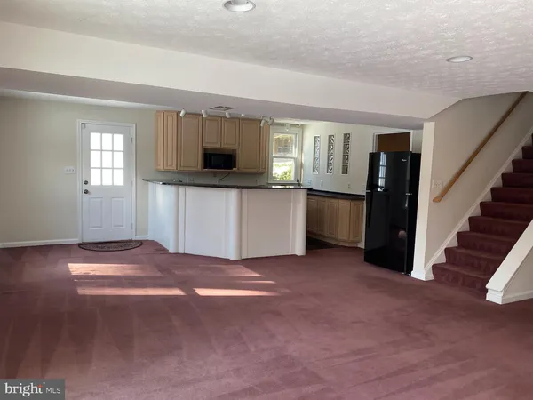 a view of a kitchen with furniture and a window