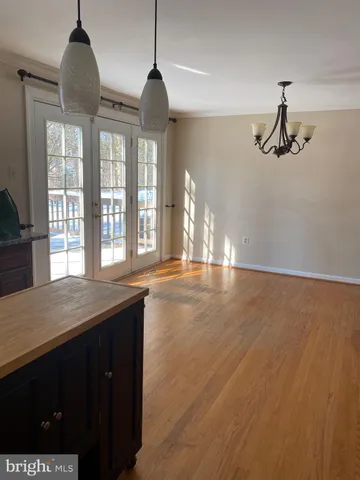 a view of empty room with wooden floor and fireplace