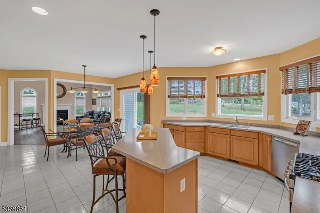 a kitchen with stainless steel appliances granite countertop a sink and a refrigerator