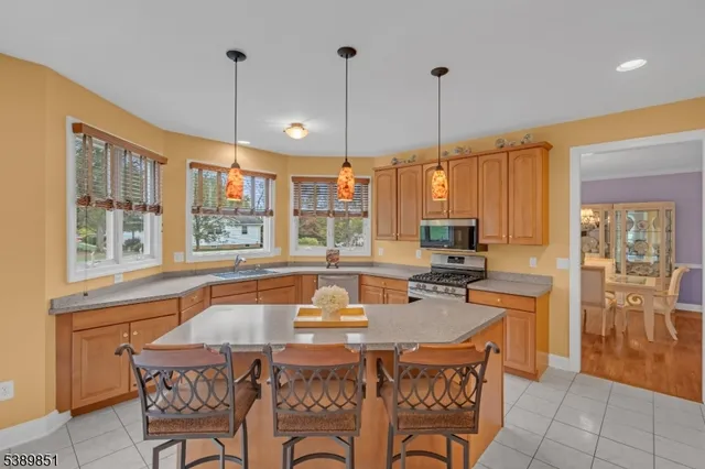 a kitchen with a table chairs and flat screen tv