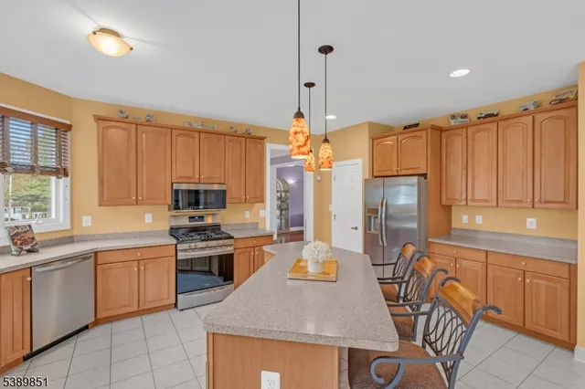 a kitchen with a sink a stove and chairs