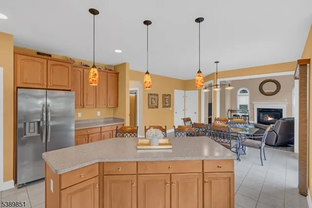 a kitchen with stainless steel appliances granite countertop a sink a stove and a refrigerator