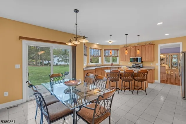 a dining room with furniture a chandelier and fireplace