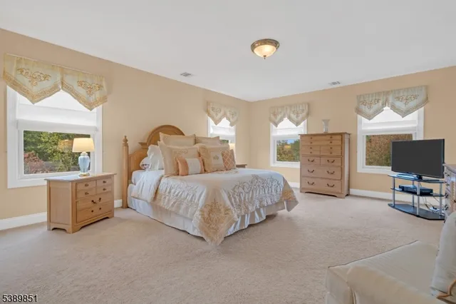 a spacious bedroom with a bed and a couch